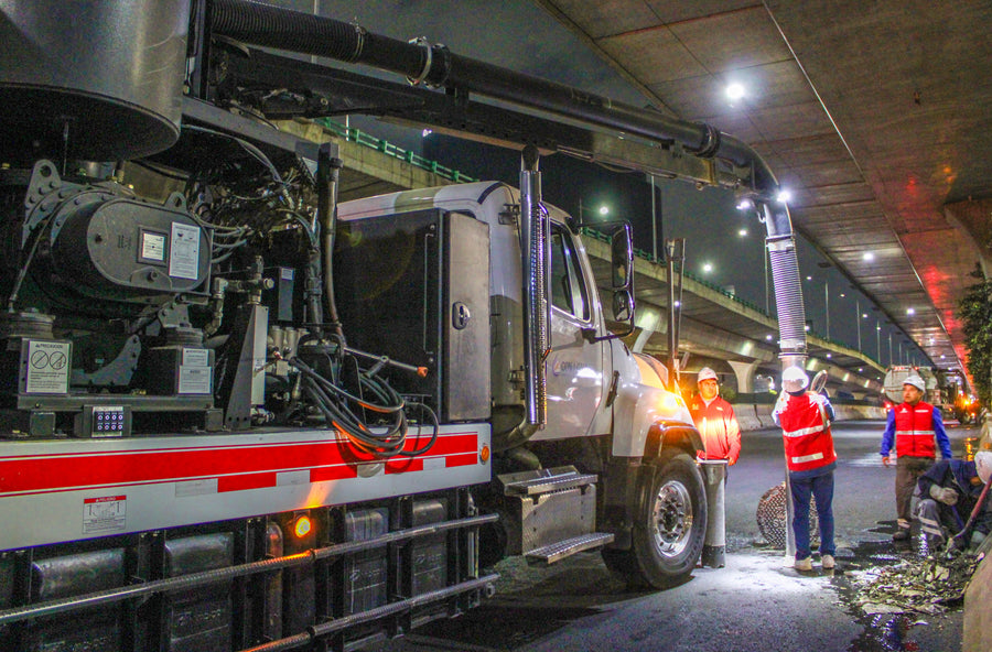 Workers operating industrial cleaning machinery