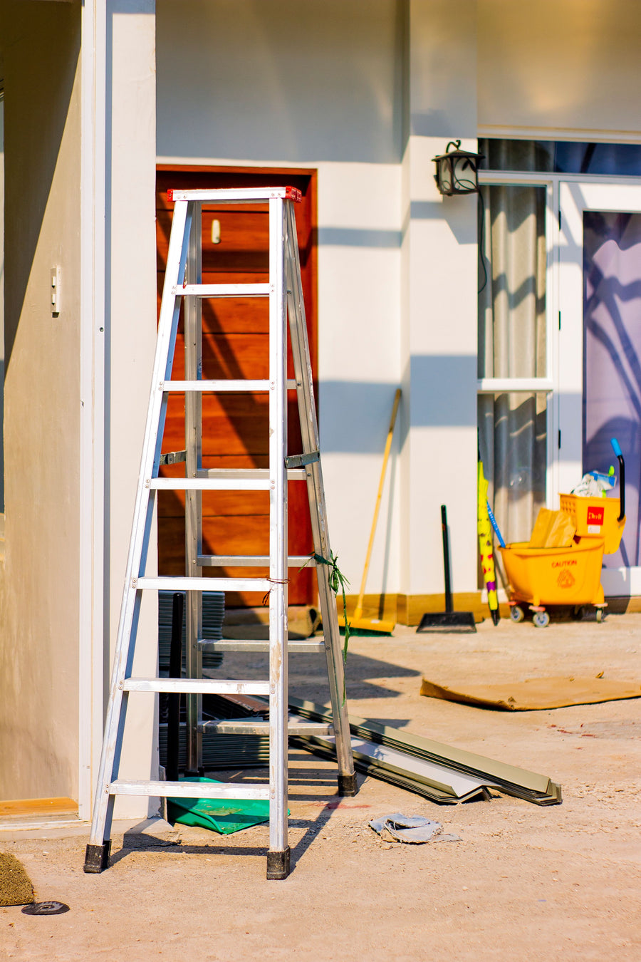 Outdoor building renovation scene with a ladder and tools
